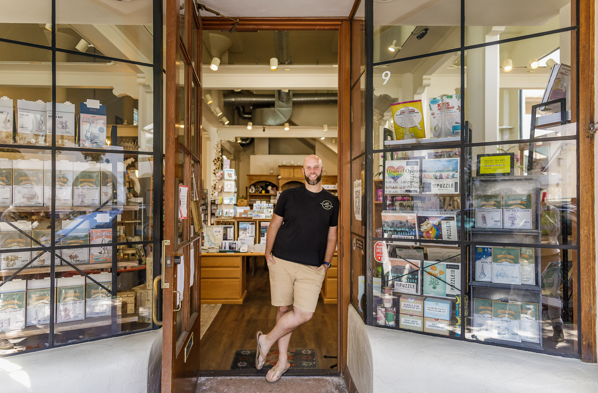 Andrew 'AJ' Rawls stands in the entrance of his store the Crafter's Library