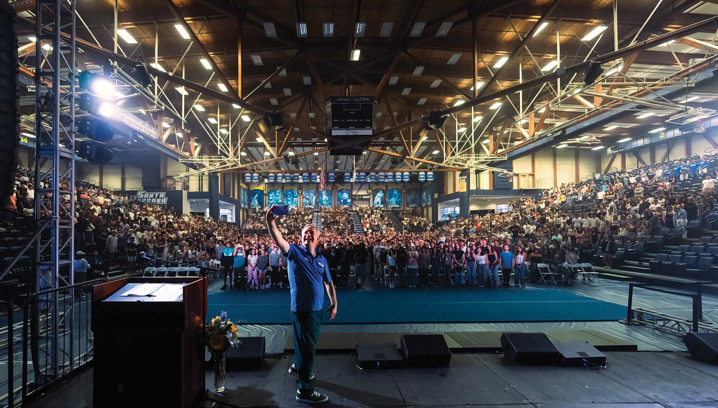 Chancellor Assanis takes a selfie on stage at the inaugural Gaucho Spirit Rally