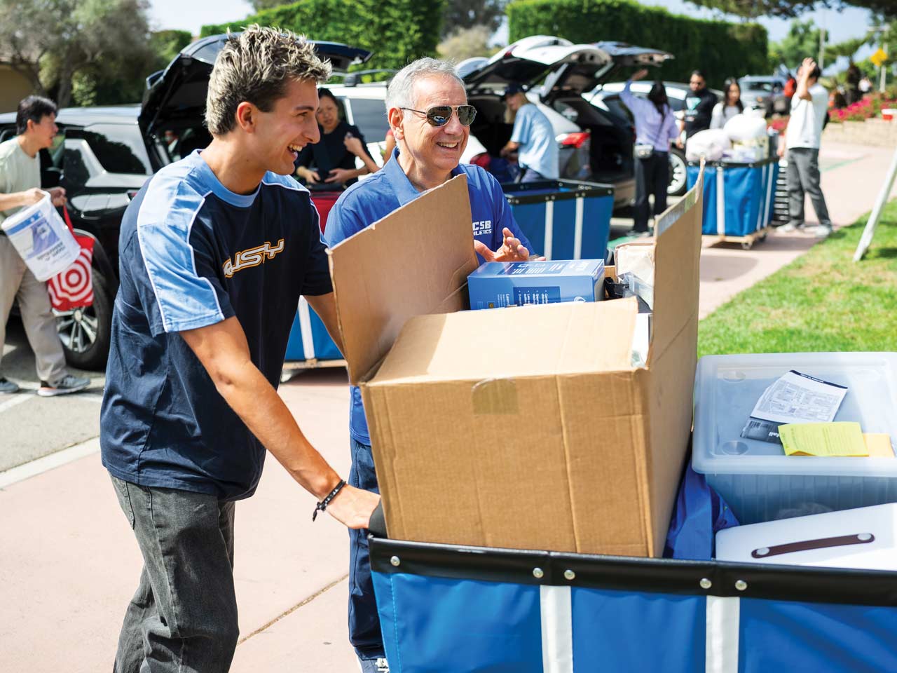 Chancellor Assanis helping a student move in