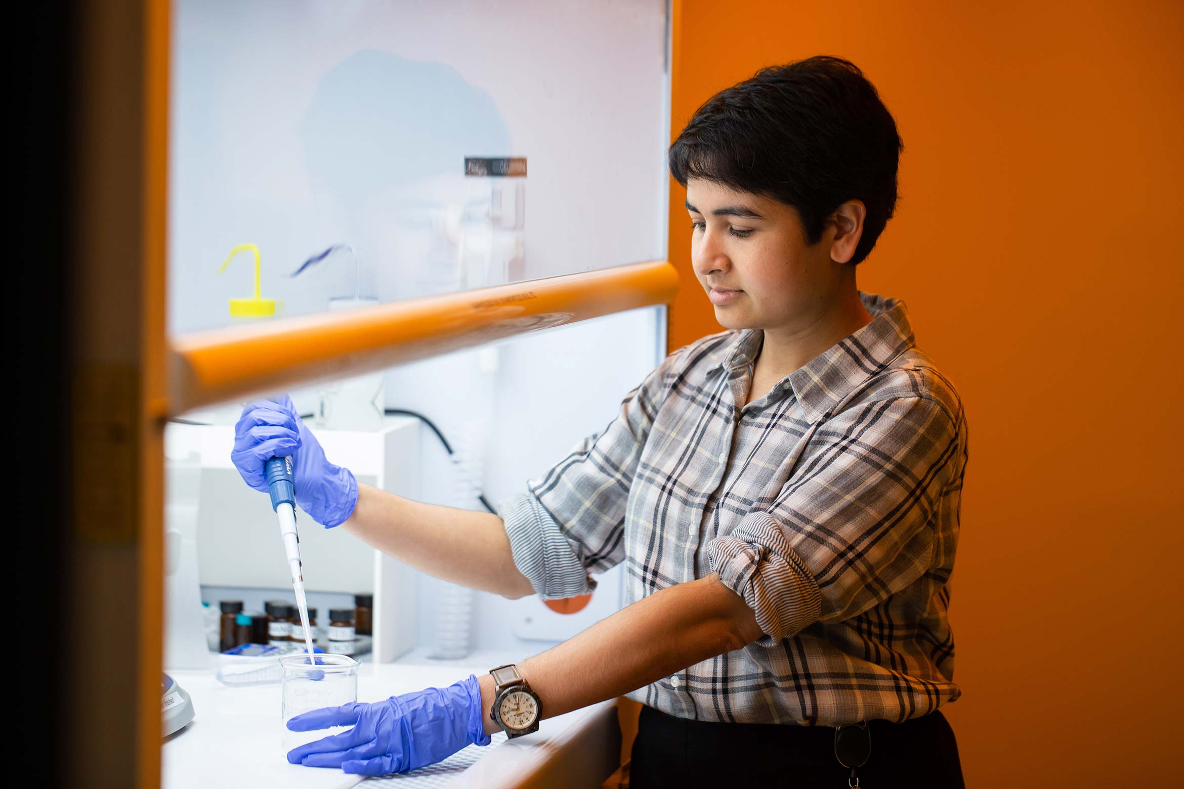 Deblina in the lab using a pipette tool