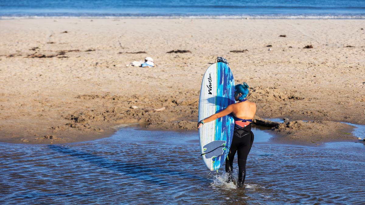 female surfer with blue hair