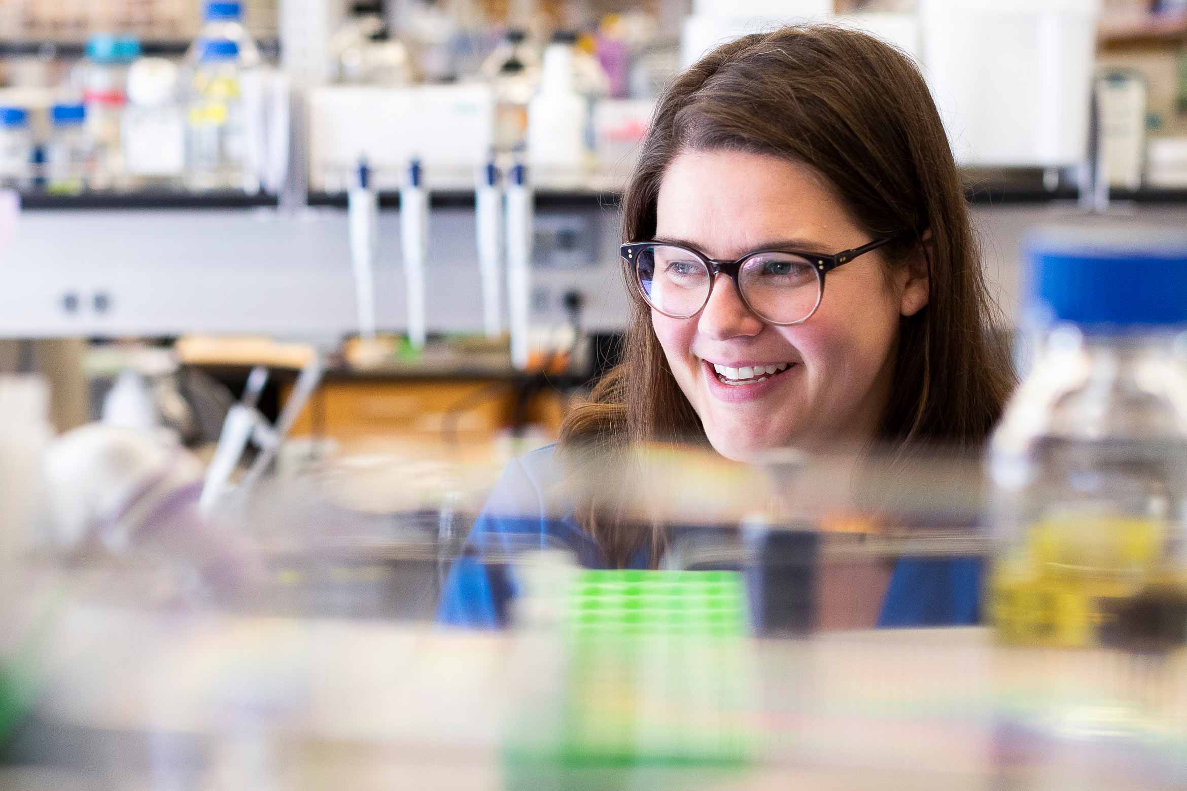 Meghan Morrissey smiling while working in her lab