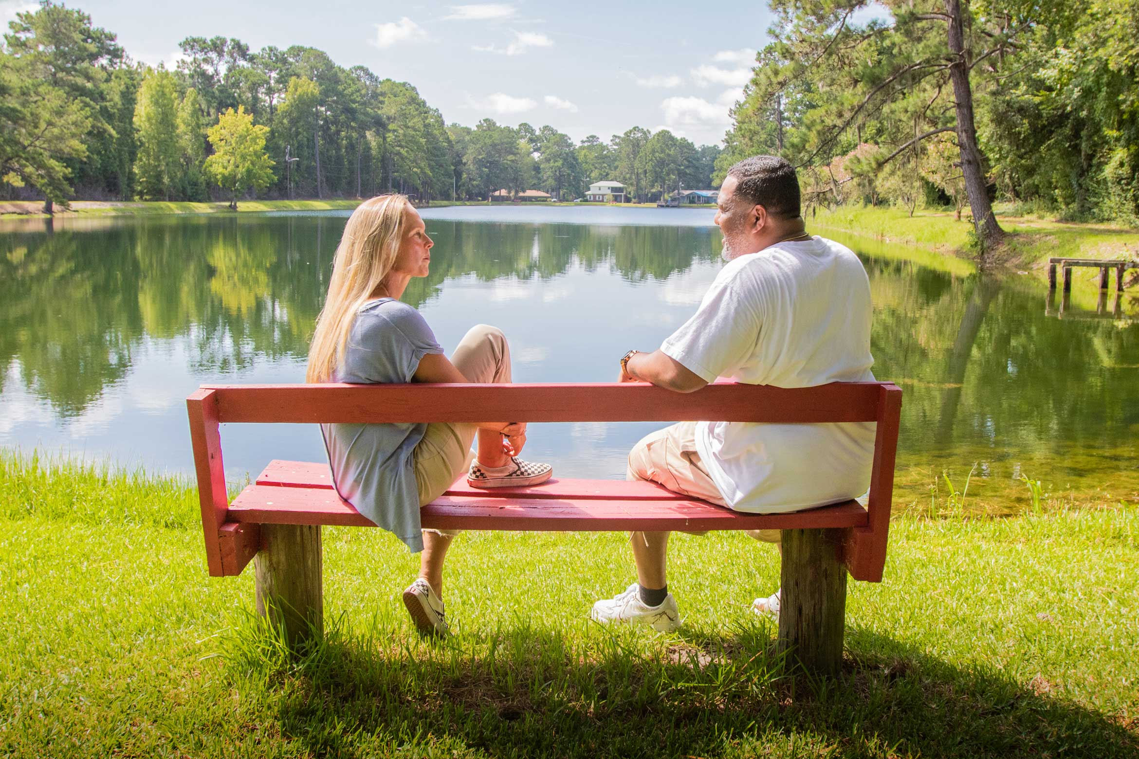 Sarah Eisner and Randy Quarterman on a red bench