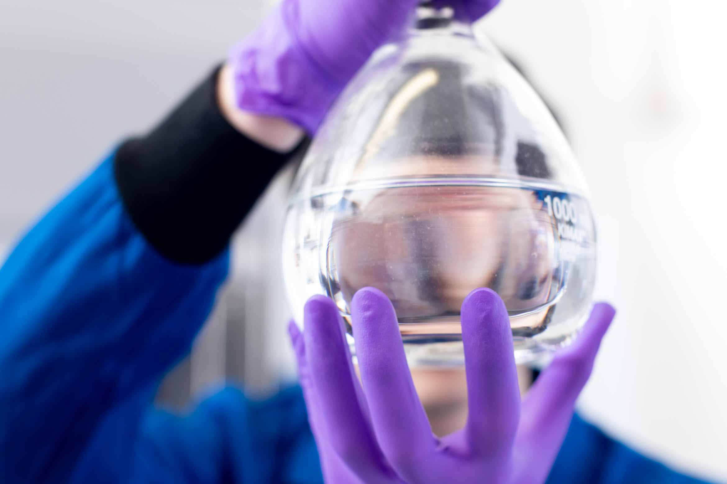 closeup photo of a researcher holding a beaker