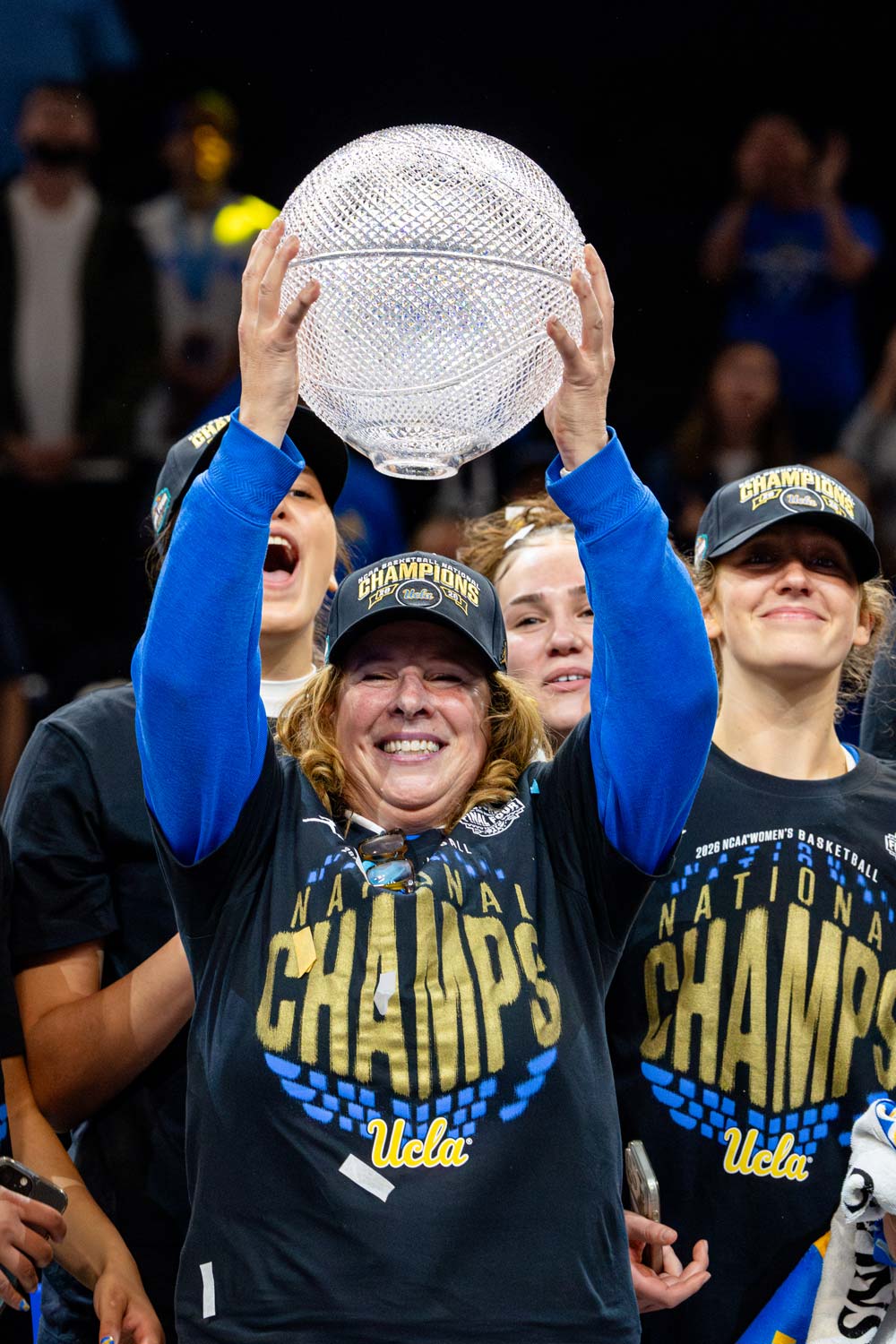 Cori Close holding a jeweled basketball trophy
