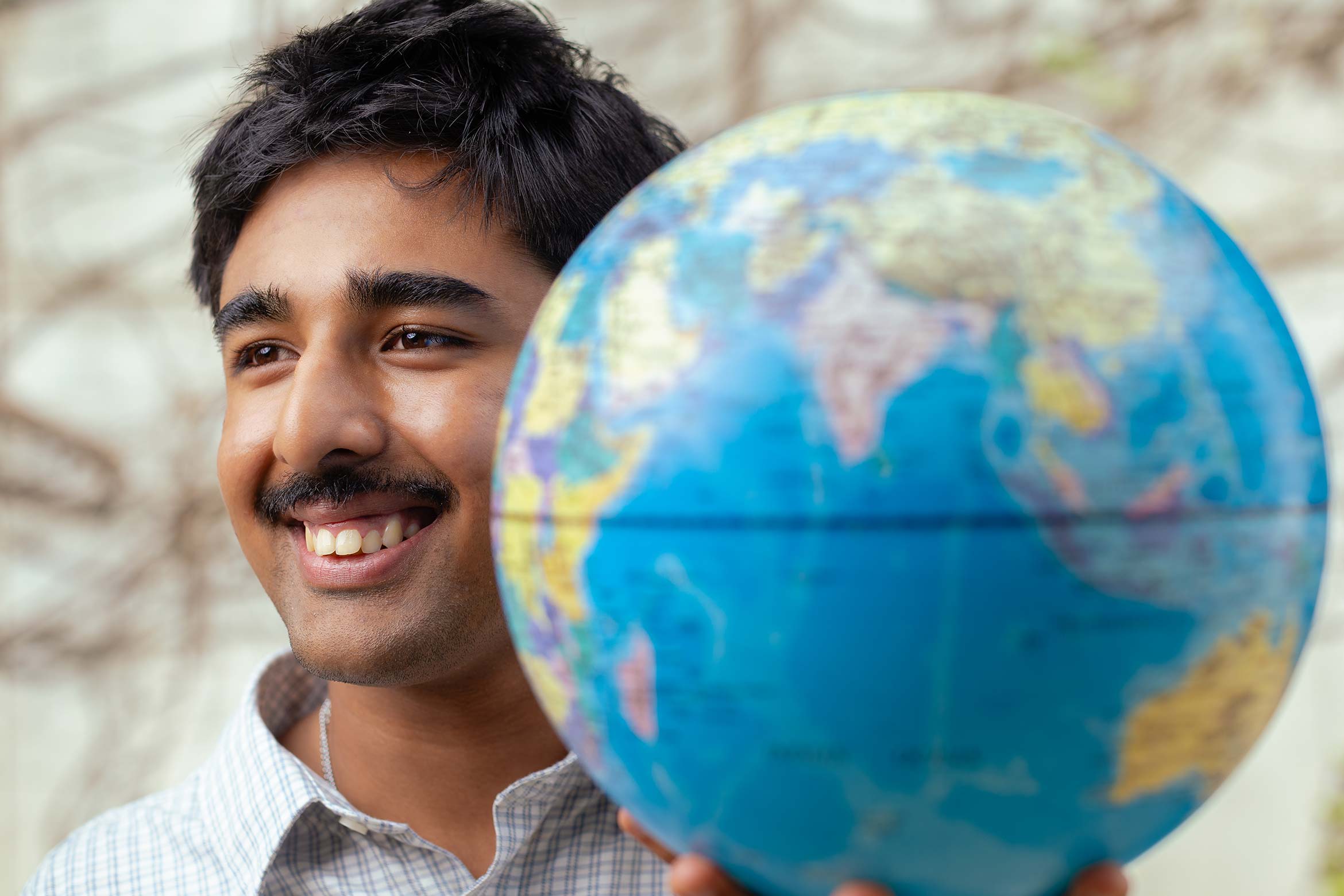 Arjun Malaviya with a globe