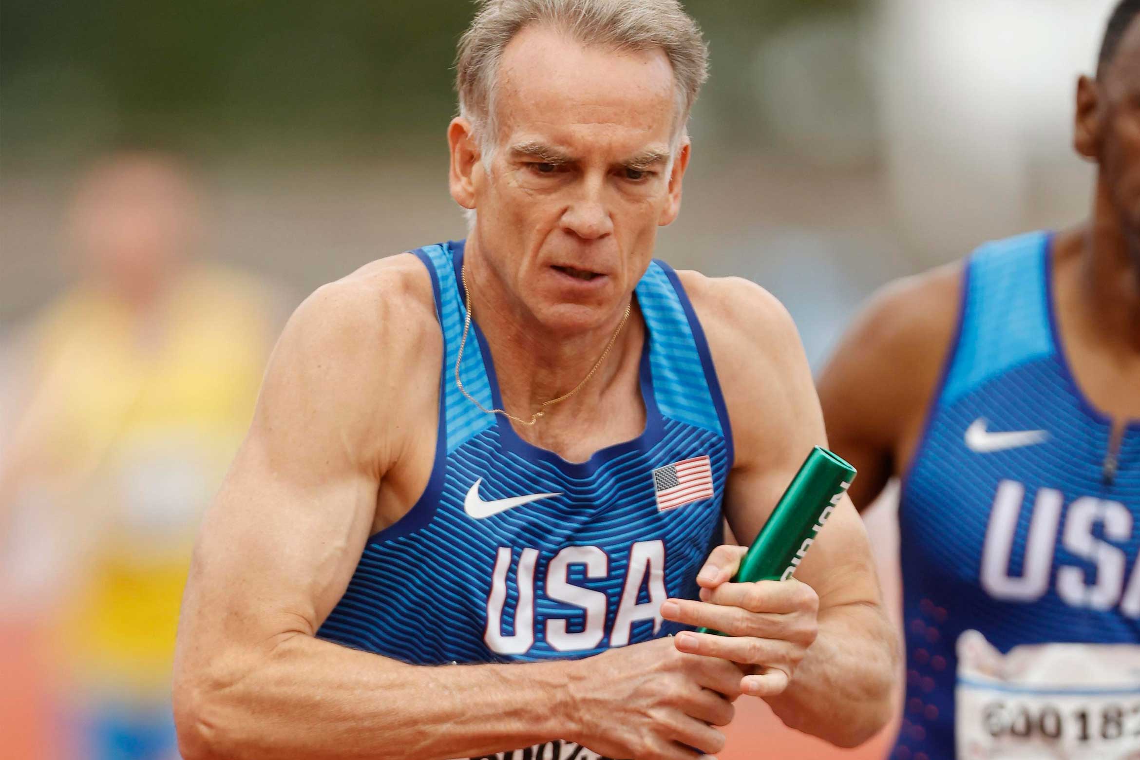 Rod Garratt running with baton