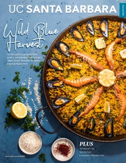 Seafood paella with ingredients on blue background