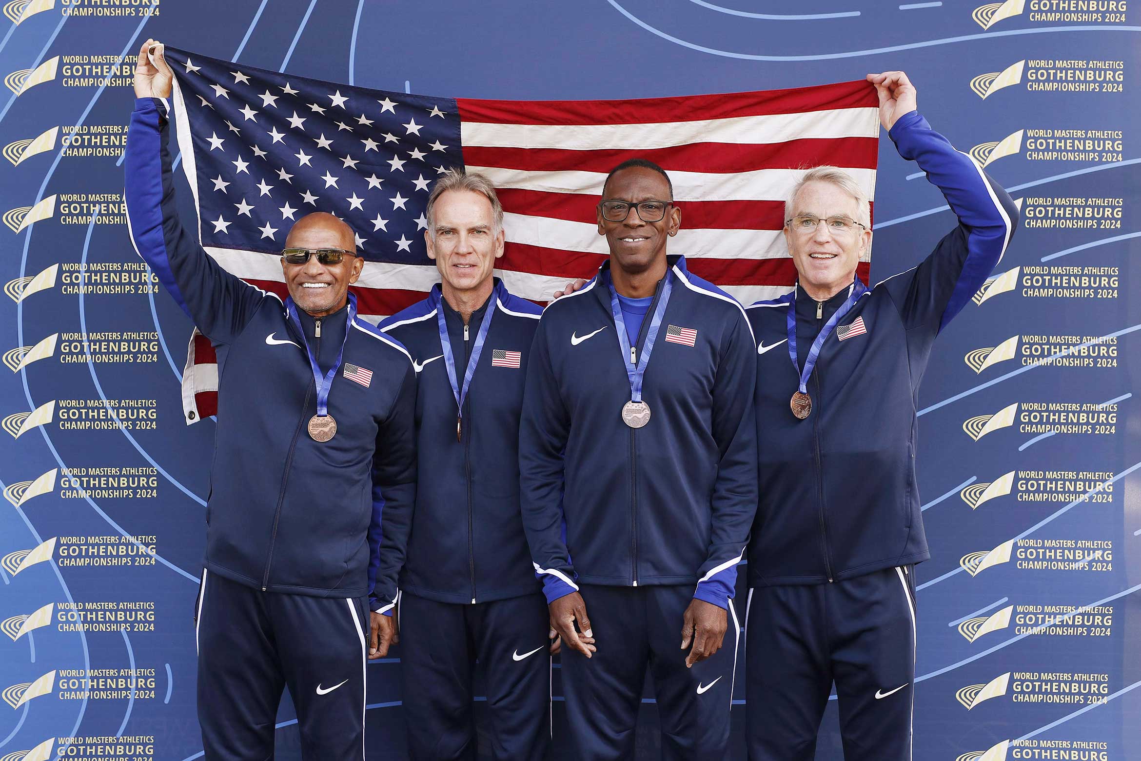 Professor Garratt with his running mates holding an american flag